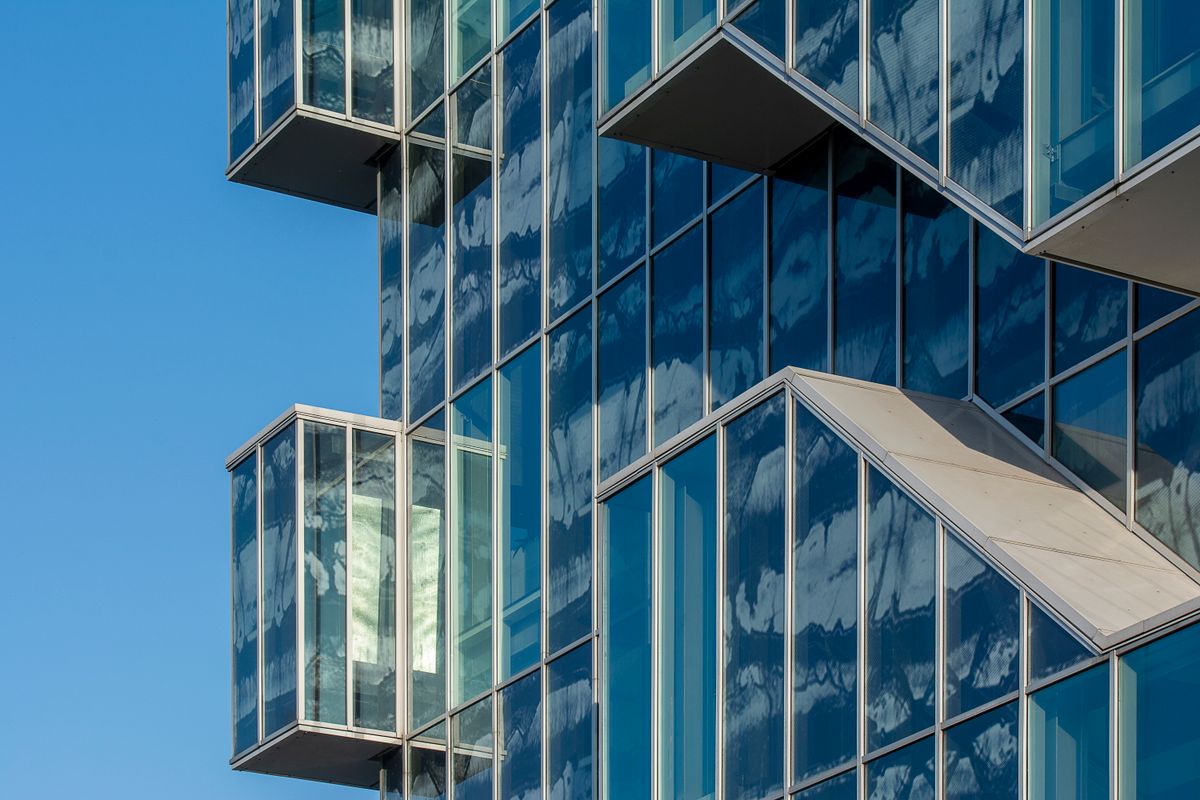 Sunlight across a modern glass building façade.